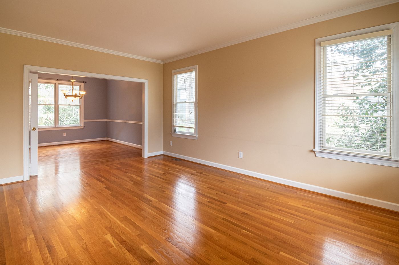 Freshly installed hardwood flooring in a bright, open living room